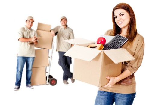 Removal team handling furniture and boxes in a South London flat move