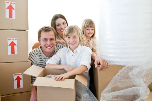 Professional movers handling a piano in a modern Elephant And Castle apartment building